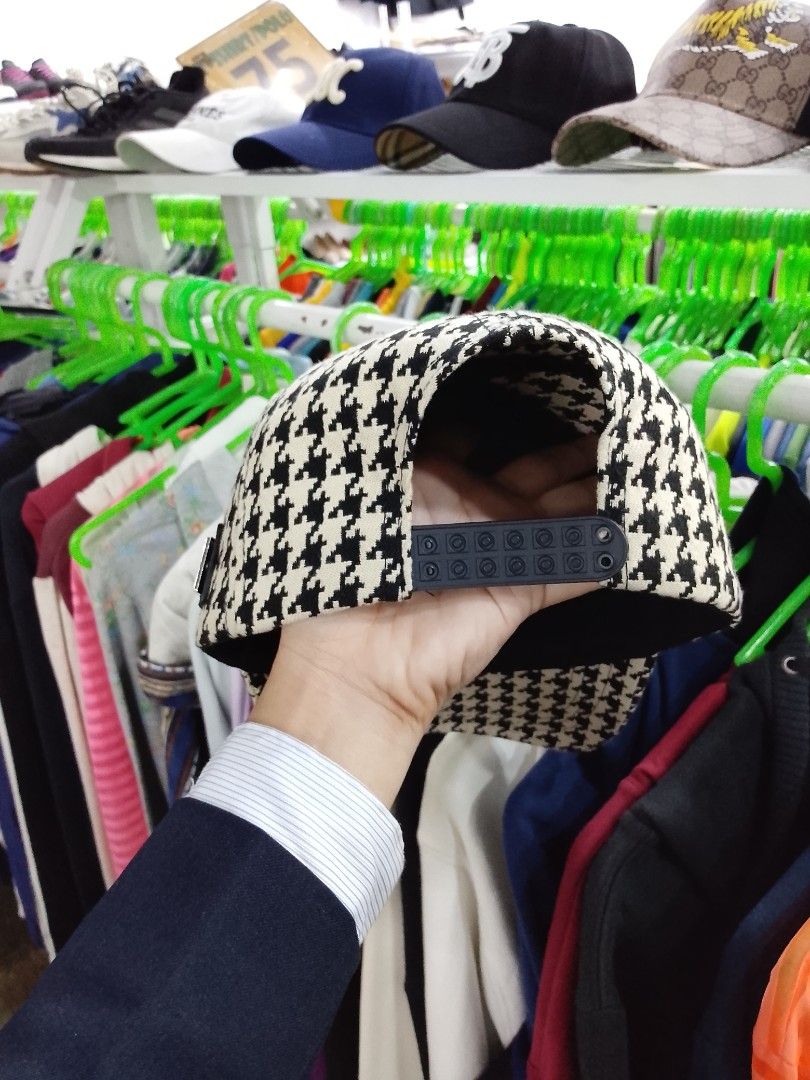 Chr!stian D!or Houndstooth Snapback Cap (Category: Caps & Hats) located in Caloocan City. Submitted by mayn_della (Listing ID 1469249799, Image 3). Description: - Iconic black-and-white houndstooth pattern - Embroidered Dior logo with a unique safety pin graphic - Premium metal Christian Dior plaque riveted on the side - Structured brim and panel construction for a sharp fit - Adjustable snapback closure at the back.