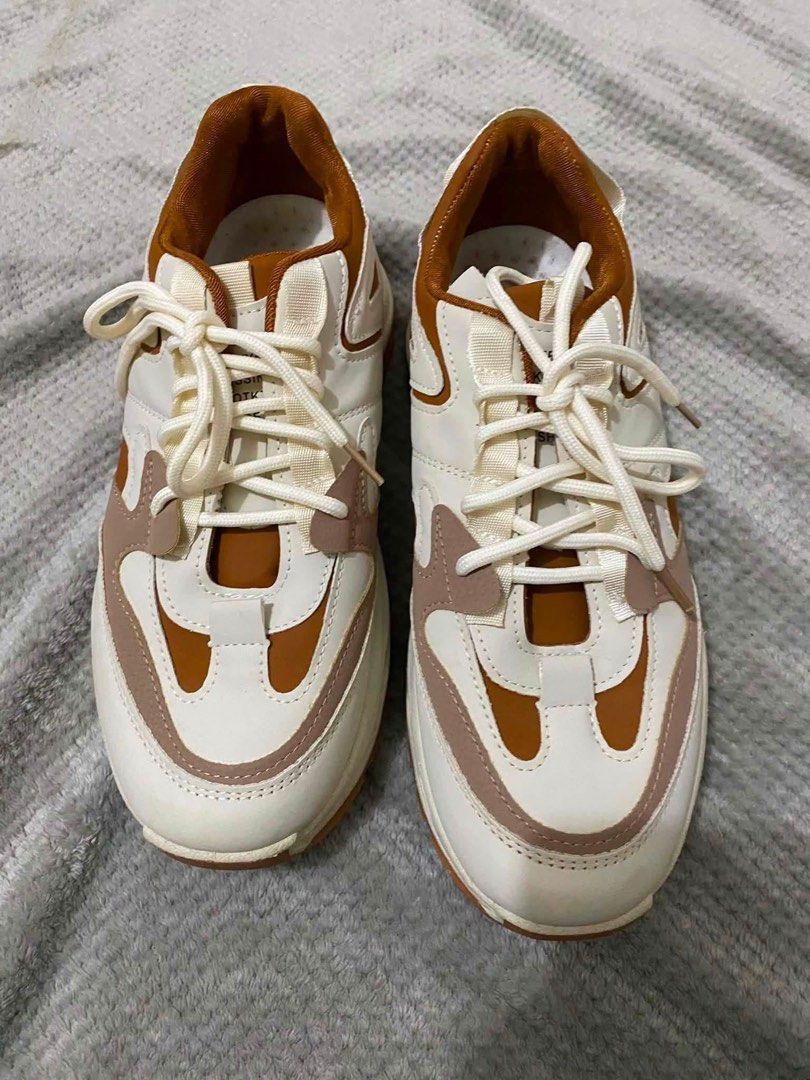 Chunky Platform Sneakers Brown White Size 44 (Category: Sneakers) located in Bacoor. Submitted by rs_finds (Listing ID 1469214233, Image 2). Description: - Color: White, tan, and brown tones - Size: 44 (marked on sole) - Sole: Thick lug soles for extra height and grip - Closure: Front lace-up with white laces - Condition: Clean uppers and fresh soles with hardly any wear on the tread.