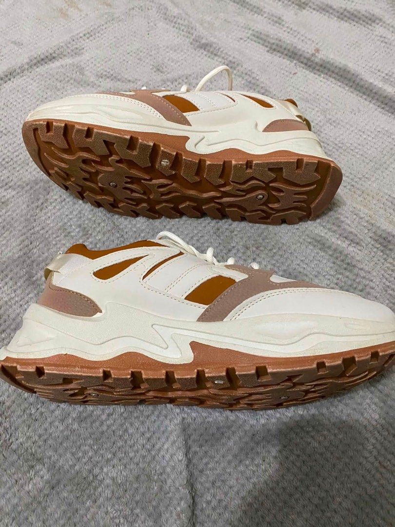 Chunky Platform Sneakers Brown White Size 44 (Category: Sneakers) located in Bacoor. Submitted by rs_finds (Listing ID 1469214233, Image 3). Description: - Color: White, tan, and brown tones - Size: 44 (marked on sole) - Sole: Thick lug soles for extra height and grip - Closure: Front lace-up with white laces - Condition: Clean uppers and fresh soles with hardly any wear on the tread.