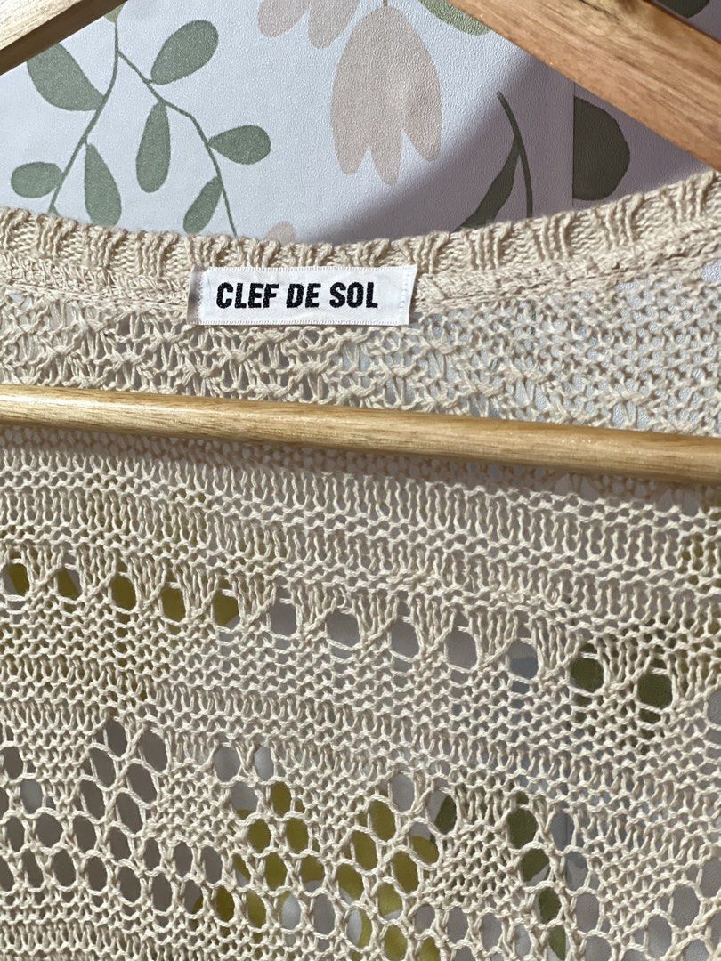 CLEF DE SOL Beige Open Knit Cardigan (Category: Coats, Jackets and Outerwear) located in Pasig City. Submitted by morilove (Listing ID 1469186304, Image 2). Description: - Brand: Clef De Sol - Color: Cream - Material: Lightweight knit with intricate open weave pattern - Closure: Wooden buttons at the front - Details: Long sleeves with ribbed cuffs - Style: Breezy layering piece ideal for sunny days and cool evenings - Condition: Excellent.