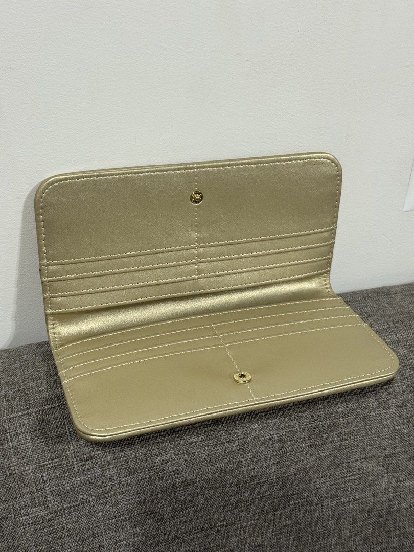 CLN Gold Embossed Long Wallet (Category: Wallets & Card holders) located in Manila. Submitted by justkayemarana (Listing ID 1469245634, Image 2). Description: - Brand: CLN - Color: Elegant Gold - Condition: Brand new (w box) - MOP: bank transfer or gcash - meetup: around bgc area only - shipping: via grab or lalamove (shipping will be shouldered by the buyer) pm for more inquiries!! :).