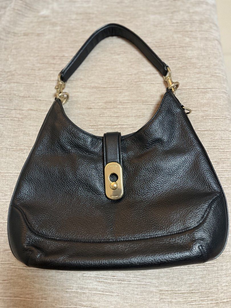Coach Black Leather Shoulder Bag (Category: Luxury Bags & Wallets) located in Bacoor. Submitted by macorda (Listing ID 1469302335, Image 1). Description: - Brand: Coach - Material: Premium black pebble leather - Hardware: Elegant gold-tone with front strap clasp closure - Strap: Single detachable leather strap with lobster clasps - Interior: Clean interior with a sturdy, structured base - Style: Timeless and versatile, perfect for daily use or ev