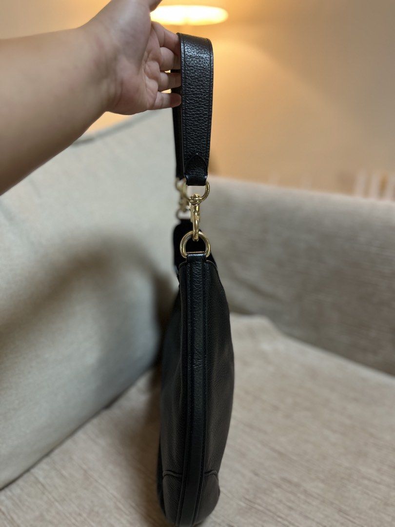 Coach Black Leather Shoulder Bag (Category: Luxury Bags & Wallets) located in Bacoor. Submitted by macorda (Listing ID 1469302335, Image 3). Description: - Brand: Coach - Material: Premium black pebble leather - Hardware: Elegant gold-tone with front strap clasp closure - Strap: Single detachable leather strap with lobster clasps - Interior: Clean interior with a sturdy, structured base - Style: Timeless and versatile, perfect for daily use or ev