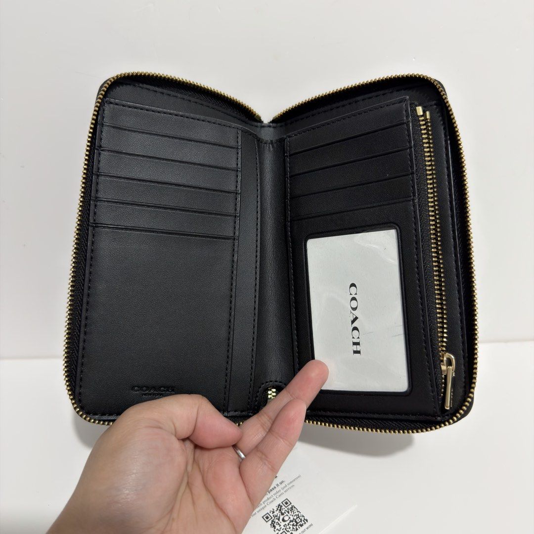 Coach Black Leather Zip Around Medium Wallet (Category: Wallets & Card holders) located in Cabanatuan. Submitted by luckypenguin.e2a414 (Listing ID 1469245447, Image 2). Description: - Authentic Coach wallet in classic black pebbled leather - Elegant gold-tone hardware with secure zip-around closure - Organized interior with multiple card slots, slip compartments, and an ID window - Immaculate condition with a clean interior/exterior and smooth z