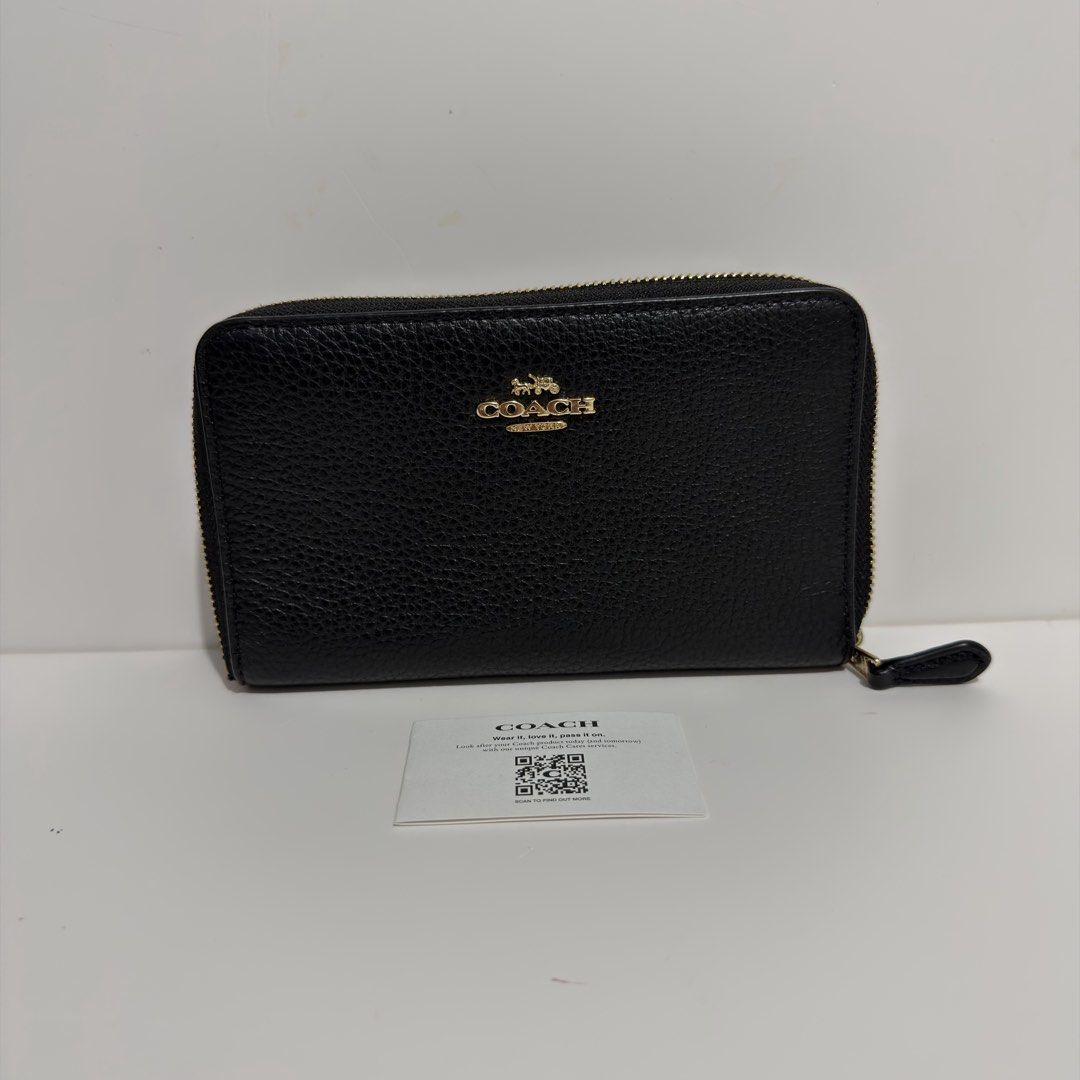 Coach Black Leather Zip Around Medium Wallet (Category: Wallets & Card holders) located in Cabanatuan. Submitted by luckypenguin.e2a414 (Listing ID 1469245447, Image 1). Description: - Authentic Coach wallet in classic black pebbled leather - Elegant gold-tone hardware with secure zip-around closure - Organized interior with multiple card slots, slip compartments, and an ID window - Immaculate condition with a clean interior/exterior and smooth z