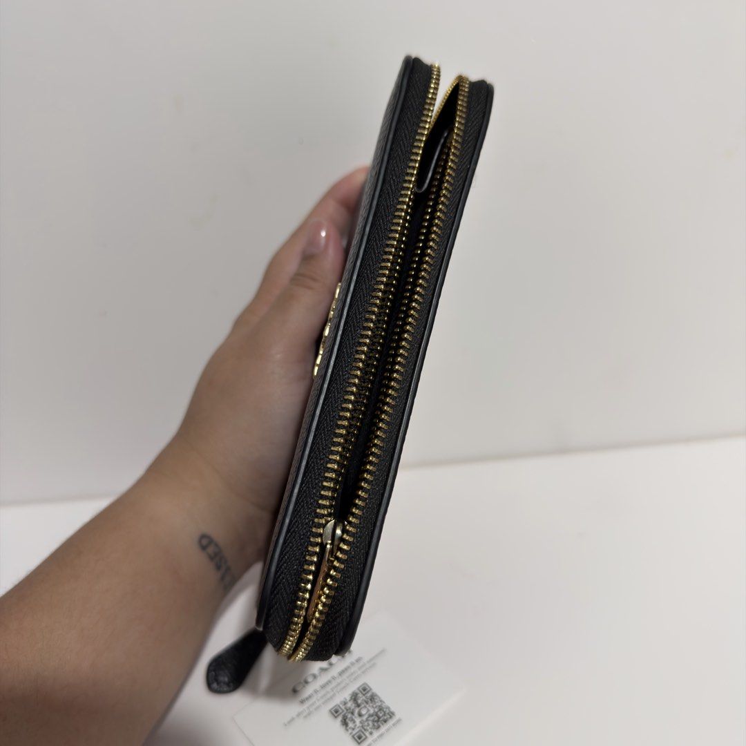 Coach Black Leather Zip Around Medium Wallet (Category: Wallets & Card holders) located in Cabanatuan. Submitted by luckypenguin.e2a414 (Listing ID 1469245447, Image 3). Description: - Authentic Coach wallet in classic black pebbled leather - Elegant gold-tone hardware with secure zip-around closure - Organized interior with multiple card slots, slip compartments, and an ID window - Immaculate condition with a clean interior/exterior and smooth z