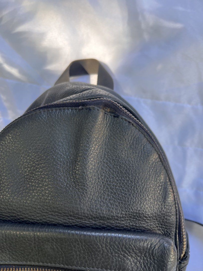 Coach Black Pebble Leather Mini Backpack with Green Straps (Category: Luxury Bags & Wallets) located in Quezon City. Submitted by rizza14ortiz (Listing ID 1469178247, Image 3). Description: - Brand: Coach - Material: Black pebble leather with gold-tone hardware - Compartments: Main compartment with dark fabric interior, front zip pocket, and interior zippered slip pocket - Straps: Olive green padded shoulder straps with adjustable black webbed lo