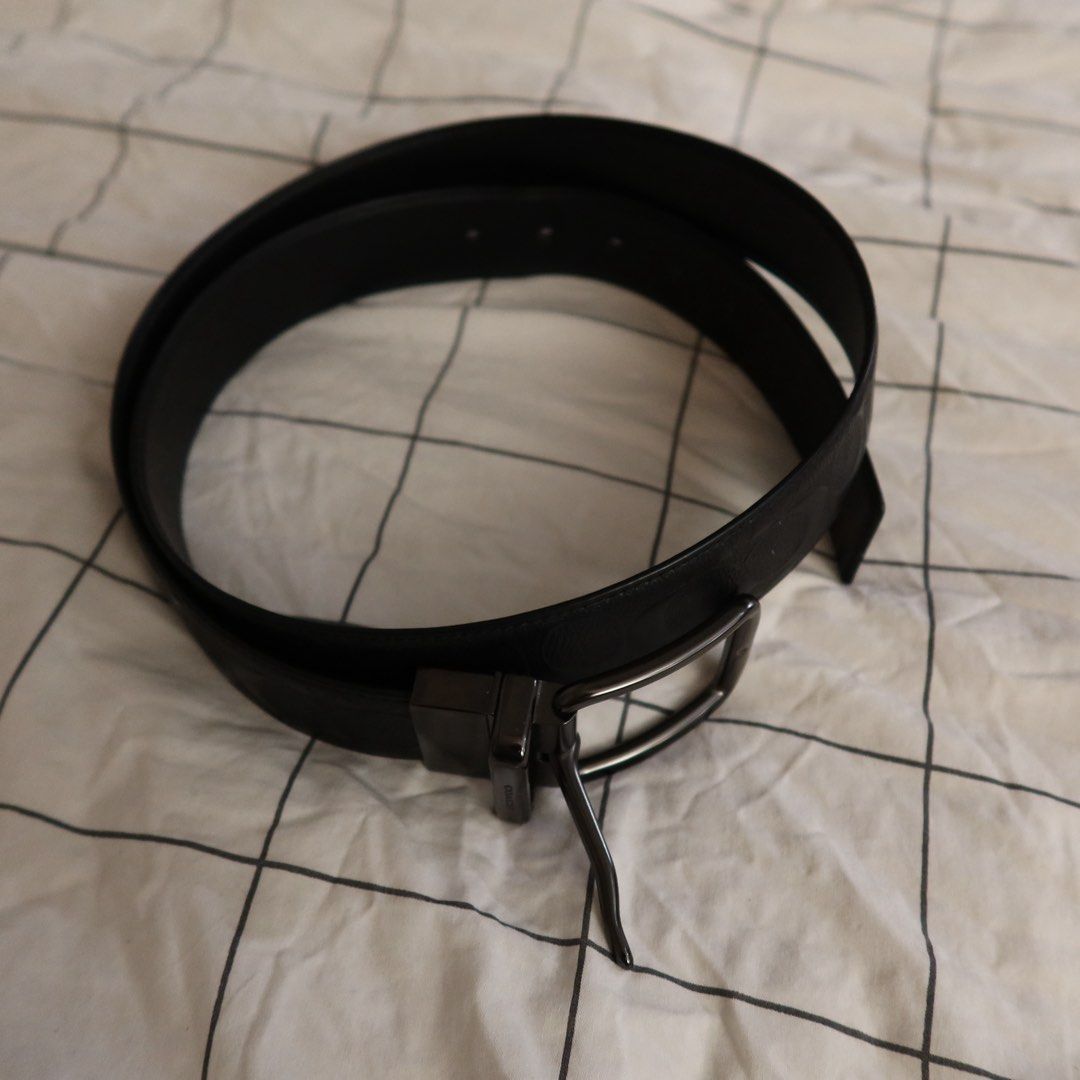 Coach Black Signature Leather Belt (Category: Belts) located in Manila. Submitted by gentlewind_62f064 (Listing ID 1469257801, Image 3). Description: - Brand: Coach - Size: 46in. from buckle - Material: Genuine leather with signature debossed pattern - Hardware: Gunmetal buckle with embossed Coach logo and rotating clasp - Design: Reversible (signature pattern on one side, solid black on the reverse) - Fit: Adjustable sizing with standard punch h