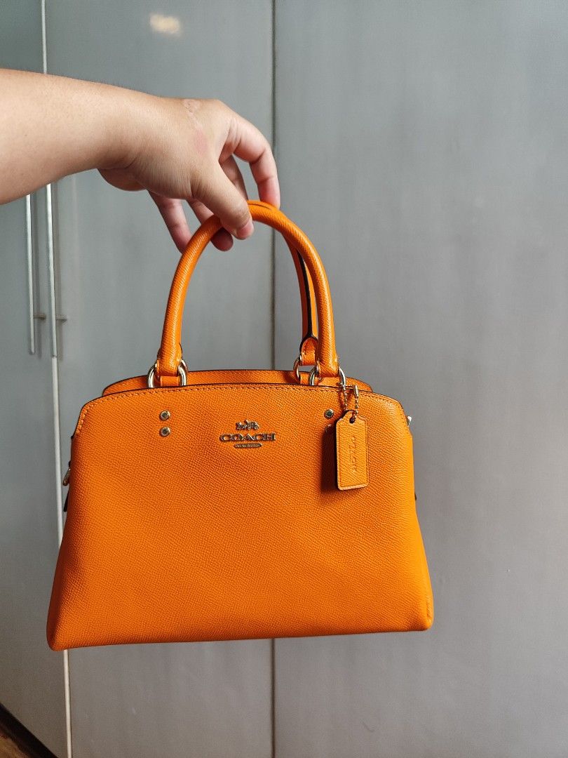 Coach Carryall Bag (Category: Luxury Bags & Wallets) located in Paranaque City. Submitted by peachmangojam (Listing ID 1469194966, Image 1). Description: Coach Mini Lillie Carryall Color: Sunbeam Orange 2 way: top handle and sling.