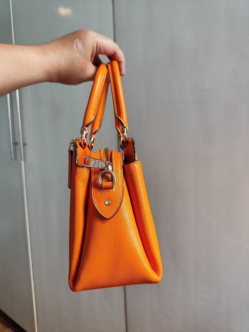 Coach Carryall Bag (Category: Luxury Bags & Wallets) located in Paranaque City. Submitted by peachmangojam (Listing ID 1469194966, Image 2). Description: Coach Mini Lillie Carryall Color: Sunbeam Orange 2 way: top handle and sling.