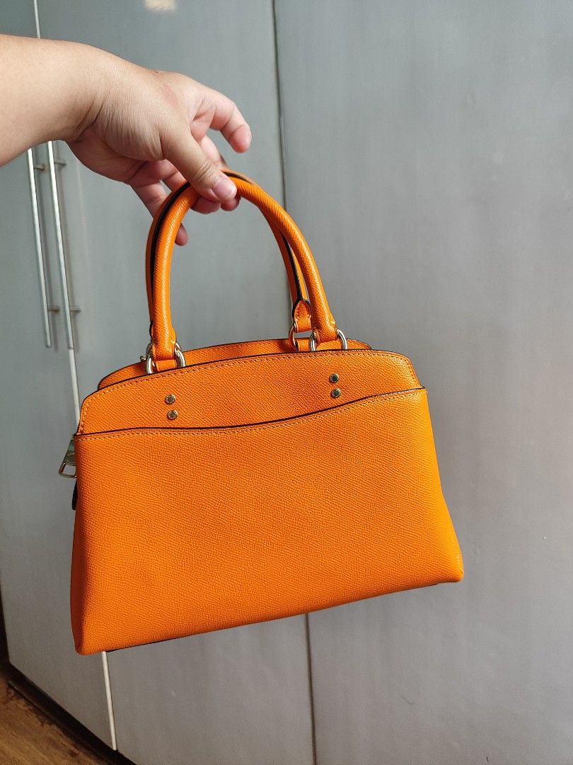 Coach Carryall Bag (Category: Luxury Bags & Wallets) located in Paranaque City. Submitted by peachmangojam (Listing ID 1469194966, Image 3). Description: Coach Mini Lillie Carryall Color: Sunbeam Orange 2 way: top handle and sling.