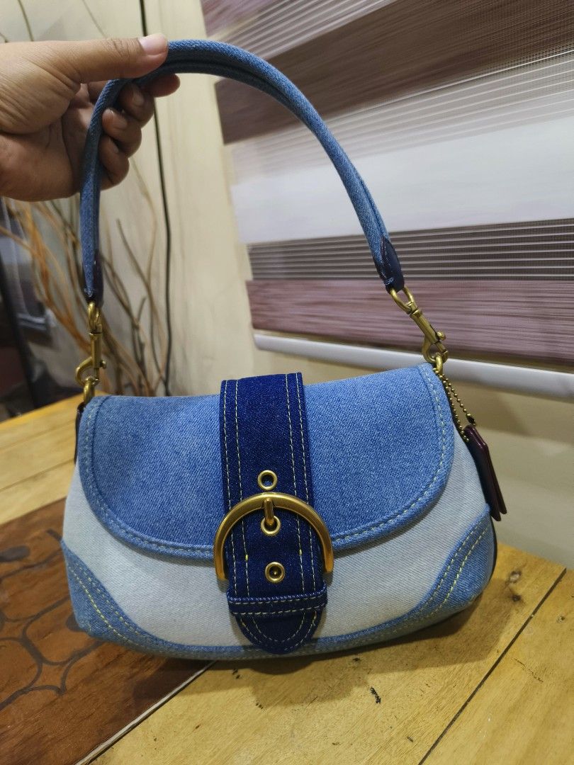 Coach Denim Shoulder Bag Flap Bag (Category: Luxury Bags & Wallets) located in General Santos City (Dadiangas). Submitted by happyrabbit_42489c (Listing ID 1469317138, Image 2). Description: - Coach denim shoulder bag in multi-tone blue denim - Elegant gold-tone hardware and secure front buckle strap closure - Features stylish contrast yellow stitching along the edges and seams - Includes matching detachable denim shoulder strap with lobster clas