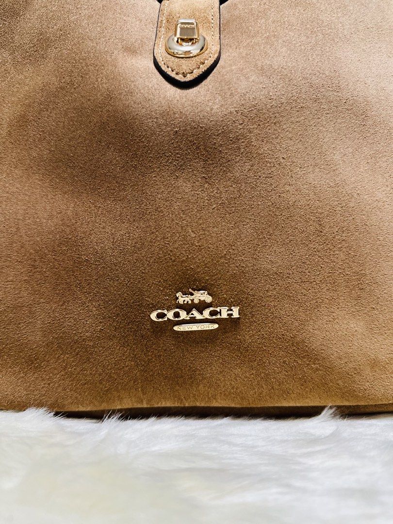Coach Hadley Brown Suede Shoulder Bag (Category: Luxury Bags & Wallets) located in Porac. Submitted by bagitupshopph (Listing ID 1469162215, Image 3). Description: 💯 Brand new from 🇺🇸 - Material: Rich brown suede with smooth leather lining - Hardware: Gold-tone with front turn-lock closure - Interior: Includes a convenient zip pocket - Included: Extender adjustable shoulder strap so it can be worn as a crossbody bag -Comes with Coach paper sho