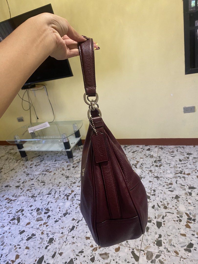Coach Leather Maroon Shoulder Bag (Category: Luxury Bags & Wallets) located in Cabanatuan. Submitted by itsajest (Listing ID 1469233434, Image 2). Description: 🍷 FOR SALE: VINTAGE COACH HOBO BAG 👜✨ Coach Bailey Hobo or Coach Harley Hobo Bag Type: Vintage bag Color: Burgundy 🍷 Condition: With signs of fading and scratches Zippers: All intact and working Inclusions: Hangtag and sling bag 📌 Legit and authentic Coach bag! 💌 DM me for condition d