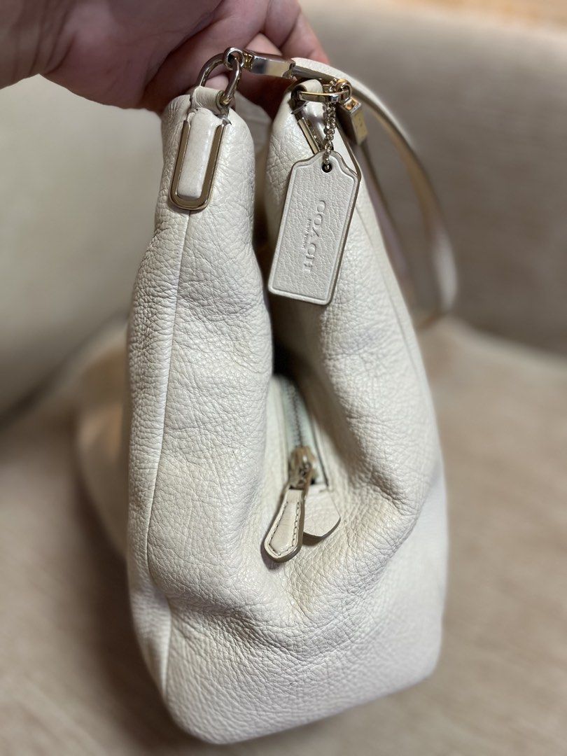 Coach Leather Shoulder Bag Off-White Cream (Category: Luxury Bags & Wallets) located in Bacoor. Submitted by macorda (Listing ID 1469302717, Image 3). Description: - Authentic Coach shoulder bag in timeless off-white pebbled leather - Spacious interior with cream fabric lining and convenient zipper pockets - Smooth main zipper closure and polished metallic hardware - Includes matching leather hangtag - Made in Vietnam - Condition: Minor scuffs on