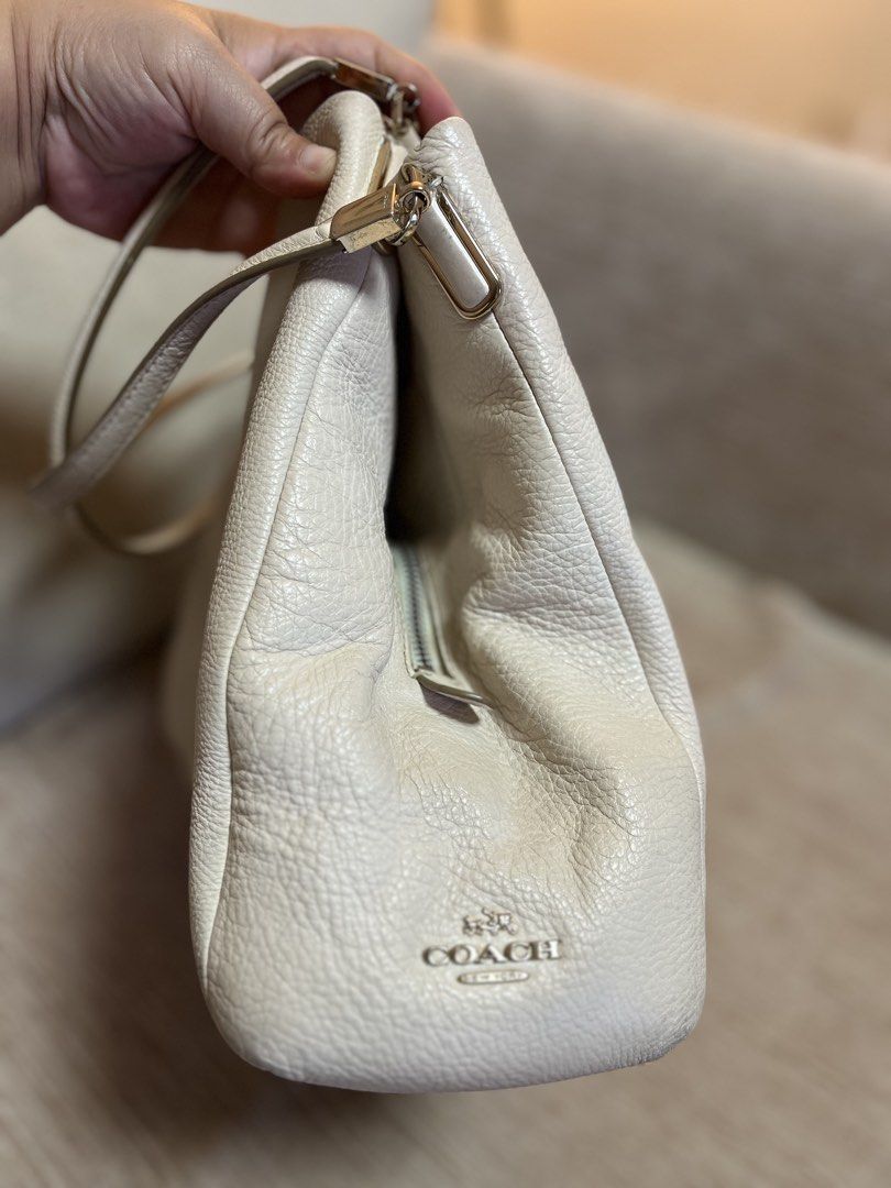 Coach Leather Shoulder Bag Off-White Cream (Category: Luxury Bags & Wallets) located in Bacoor. Submitted by macorda (Listing ID 1469302717, Image 2). Description: - Authentic Coach shoulder bag in timeless off-white pebbled leather - Spacious interior with cream fabric lining and convenient zipper pockets - Smooth main zipper closure and polished metallic hardware - Includes matching leather hangtag - Made in Vietnam - Condition: Minor scuffs on