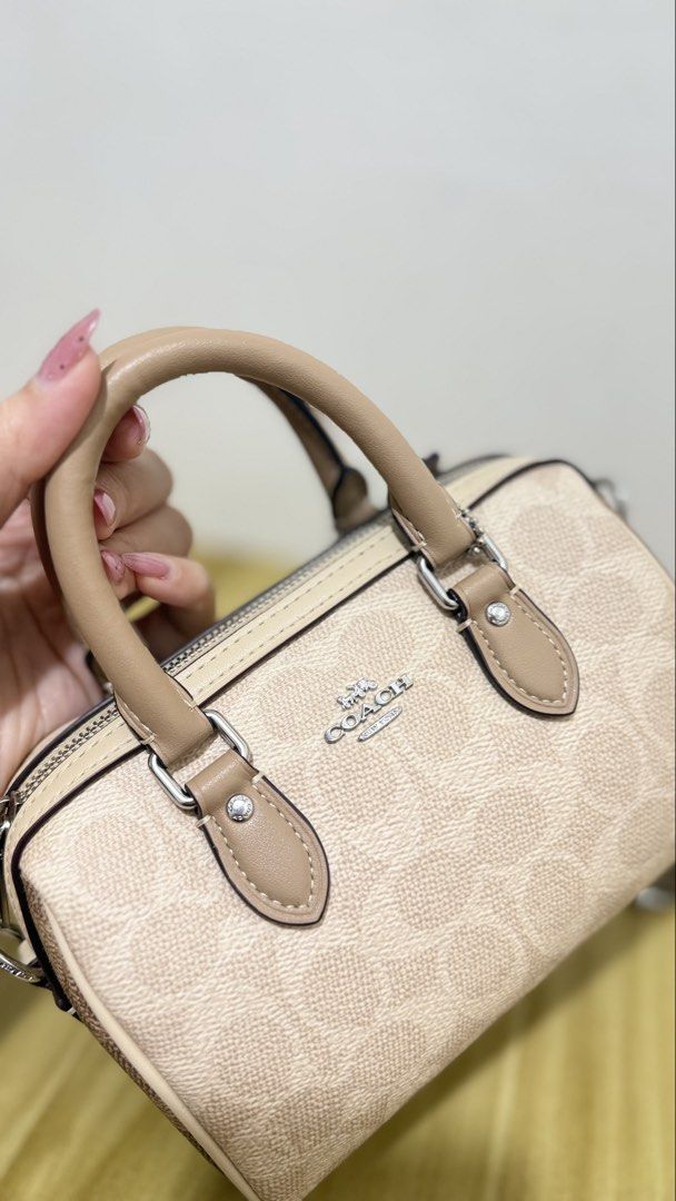 Coach Mini Rowan Crossbody (Category: Luxury Bags & Wallets) located in Caloocan City. Submitted by tokyo112419 (Listing ID 1469180347, Image 2). Description: - Authentic Coach Mini Rowan Crossbody - Color: Sand Taupe Multi (Signature Coated Canvas) - Style Number: CW330 - Silver-tone hardware with zip top closure - Includes top handle and detachable shoulder strap - Brand new with original $328 USD retail tag - Interior story patch: NBF2591-CW33