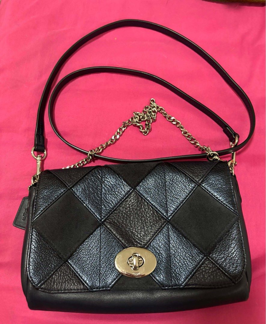 Coach Patchwork Quilted Leather Crossbody Bag (Category: Cross-body Bags) located in Indang. Submitted by lornacmtl (Listing ID 1469224482, Image 2). Description: - Authentic Coach crossbody bag in black and iridescent blue - Unique patchwork leather and suede panel design - Silver-tone hardware with front flap twist-lock closure - Stylish chain-link accent draped across the front - Removable black leather shoulder strap with lobster clasps - Cle