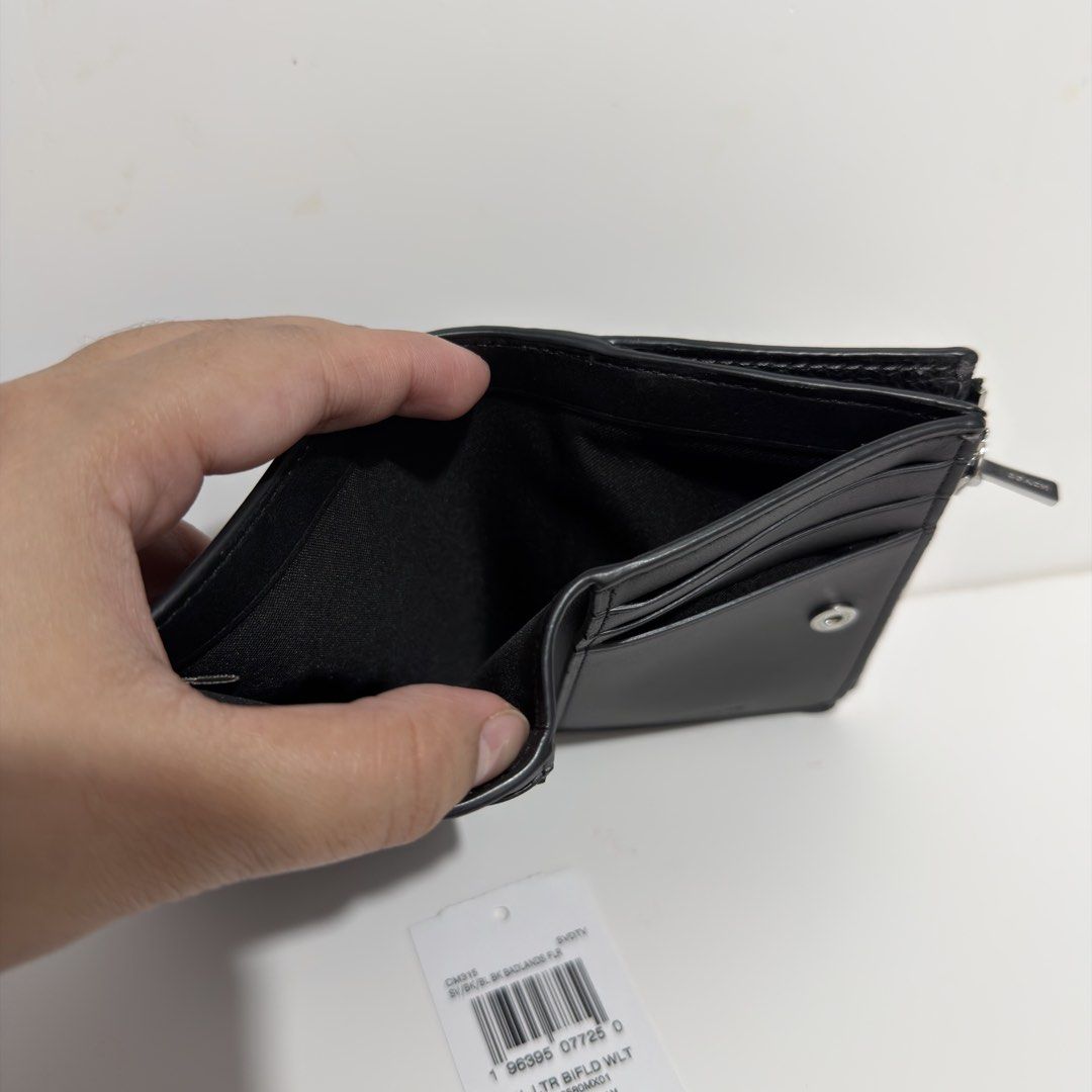 Coach PBL LTR BIFLD WLT Black Wallet (Category: Wallets & Card holders) located in Cabanatuan. Submitted by luckypenguin.e2a414 (Listing ID 1469245508, Image 3). Description: - Authentic Coach bifold wallet in classic black pebble leather - Brand new with original retail price tag attached - Convenient side zip coin pocket and secure snap closure - Multiple card slots and spacious cash compartment - Sleek silver-tone hardware and clean interior l