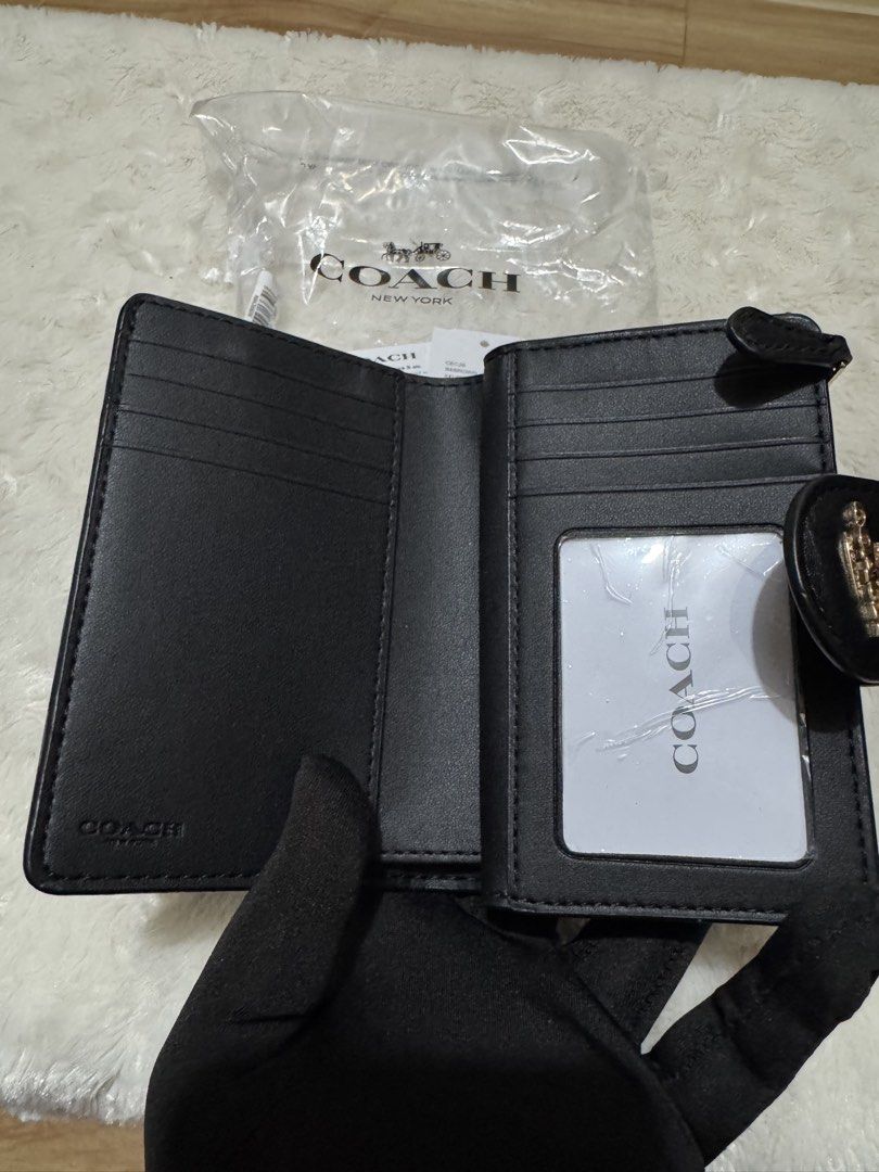 Coach Signature Medium Corner Zip Wallet Black Brown (Category: Wallets & Card holders) located in Carmona. Submitted by outletshopper.ph (Listing ID 1469327649, Image 3). Description: Authentic Coach medium wallet in classic black and brown signature canvas. Features gold-tone hardware, a secure snap closure, multiple card slots, an ID window, a bill compartment, and a back zip coin pocket. Brand new with original tags and plastic wrapping. Perf