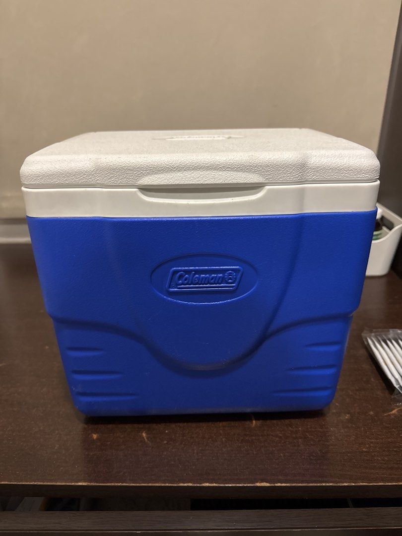 Coleman Blue and White Cooler Box (Category: Food Organization & Storage) located in Quezon City. Submitted by vsaint (Listing ID 1469232469, Image 1). Description: - Authentic Coleman cooler box in classic blue and white - Keeps food and drinks ice-cold for camping, outdoor trips, and beach days - Clean interior with convenient molded cup holders built into the lid - Durable, sturdy plastic construction with an embossed Coleman logo on the front