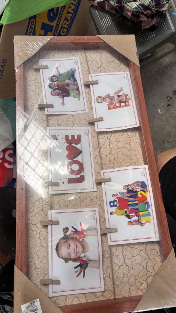 Collage Photo Frame with Clothespins (Category: Frames & Pictures) located in Caloocan City. Submitted by boldcrystal.64c51d (Listing ID 1469230584, Image 1). Description: - Brand new & in original packaging: Still sealed in plastic with corner protectors intact - Holds 5 photos: Perfect for showcasing family memories, baby milestones, or art - Unique design: Wooden frame featuring a stylish crackled texture background - Cute display: Includes mi