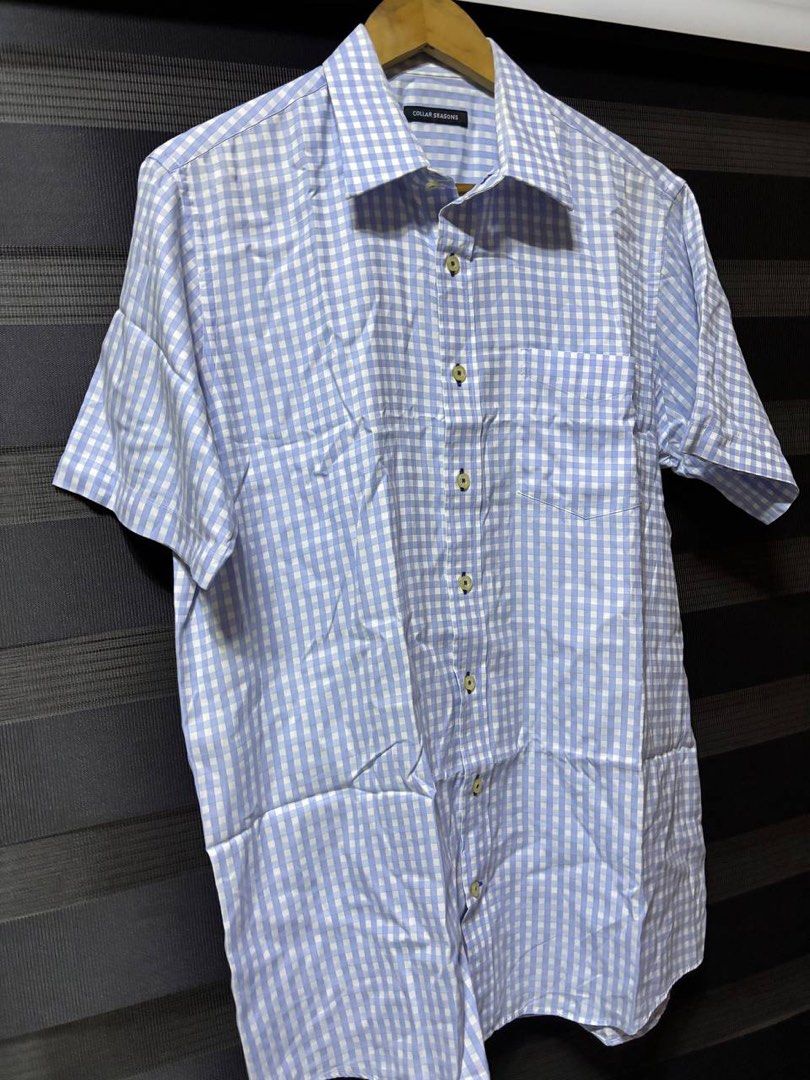 Collar Seasons Light Blue Gingham Short Sleeve Button Down Polo (Category: Tshirts & Polo Shirts ) located in Pasig City. Submitted by abogadosupremo (Listing ID 1469342458, Image 3). Description: - Brand: Collar Seasons - Pattern: Light blue and white gingham check - Style: Short-sleeve button-down shirt with classic collar and front chest pocket - Fabric: Lightweight and comfortable, perfect for smart-casual or office wear - Condition: Clean ov