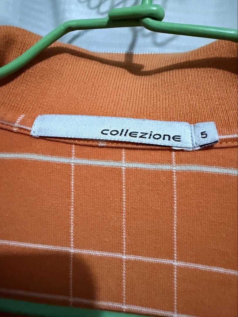 Collezione C2 Polo Shirt (Category: Tshirts & Polo Shirts ) located in Manila. Submitted by clothesandcollectibles (Listing ID 1469354190, Image 2). Description: Collezione C2, Features a vibrant orange base with a clean, modern white windowpane grid/check pattern..