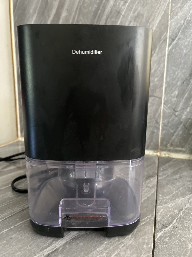 Compact Black Dehumidifier with Clear Water Tank (Category: Air Purifiers & Dehumidifiers) located in Santo Tomas. Submitted by yann1998 (Listing ID 1469164718, Image 1). Description: - Color: Sleek black compact design - Tank: Clear plastic water tank at the bottom for easy monitoring - Power: Plugs directly into standard wall outlets - Benefit: Keeps small rooms dry, fresh, and free from excess moisture - Condition: Tested and 100% working grea