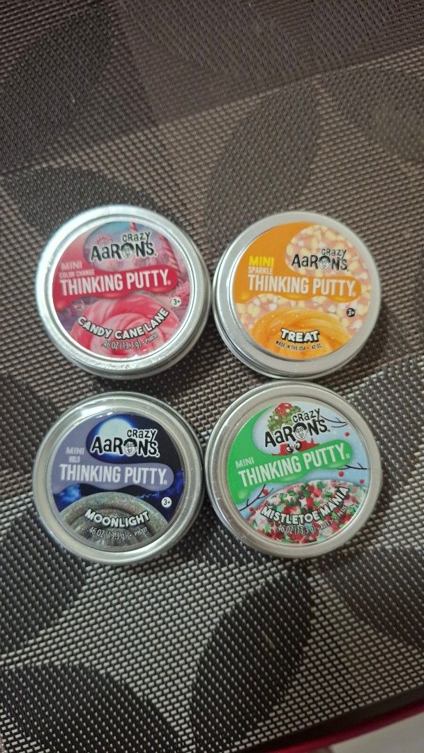 Crazy Aaron's Thinking Putty (Mini) (Category: Kids Toys) located in Pasay City. Submitted by mshannahpi (Listing ID 1469261679, Image 1). Description: - Brand new and unopened Crazy Aaron's mini thinking putty - Available: Treat, Mistletoe Mania, Candy Cane Lane, and Moonlight - Size: 0.46 oz per metal tin - Great as fidget toys, stocking stuffers, or party favors.