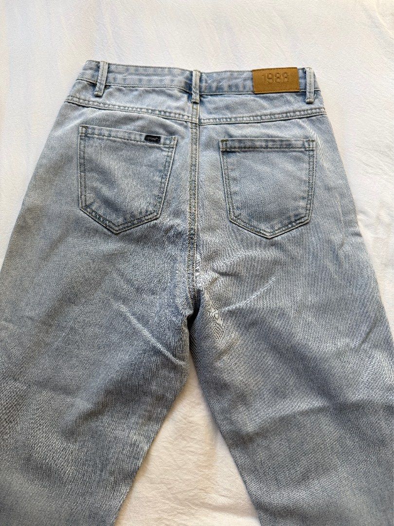 Crissa High Waist Denim Jeans (Category: Jeans) located in Manila. Submitted by the.prelovedcloset (Listing ID 1469254802, Image 2). Description: - Brand: Crissa - Size: Fits 24-26 - Style: High-waist, straight-leg denim - Wash: Light wash with a soft faded effect - Details: Classic five-pocket design, button fly closure, belt loops, and a vintage '1983' tan leather back patch - Condition: Excellent, comfortable fit.
