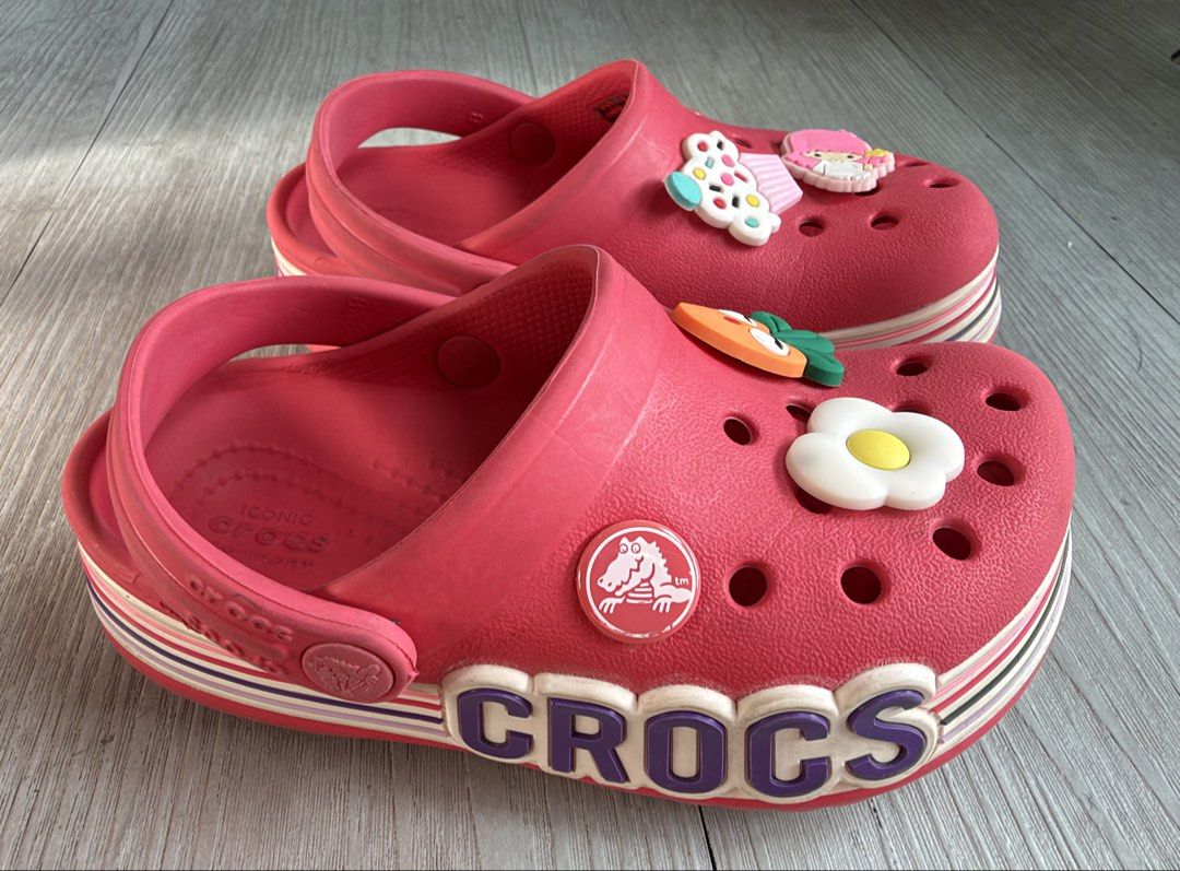 Crocs Bayaband Clog with Jibbitz Charms (Category: Babies & Kids Fashion) located in Quezon City. Submitted by warmrabbit_414908 (Listing ID 1469164701, Image 2). Description: - Size: C8 - Features: Bold side lettering and pivoting heel strap - Includes: Fun Jibbitz charms (fried egg, carrot, cupcake, anime character) - Comfort: Iconic Crocs comfort footbed - Condition/Use: Great casual footwear option.