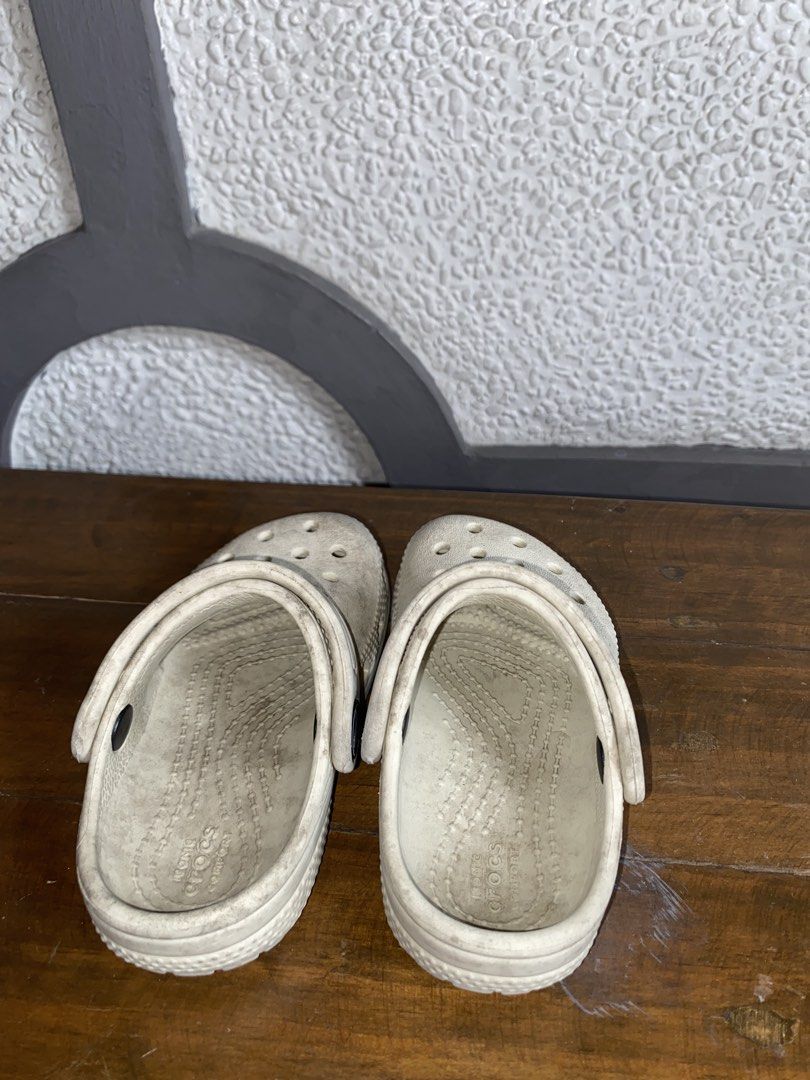 Crocs Classic Clogs White Size 6 (Category: Slippers and slides) located in Manila. Submitted by pems25 (Listing ID 1469210496, Image 2). Description: - Item: White Crocs Clogs - Size: 6 (embossed on sole) - Features: Classic slip-on design, ventilation ports, and included heel straps - Comfort: Iconic Crocs comfort footbed - Condition: Pre-loved with noticeable dirt and wear marks all over the surface; soles have normal dirt buildup - Perfect fo