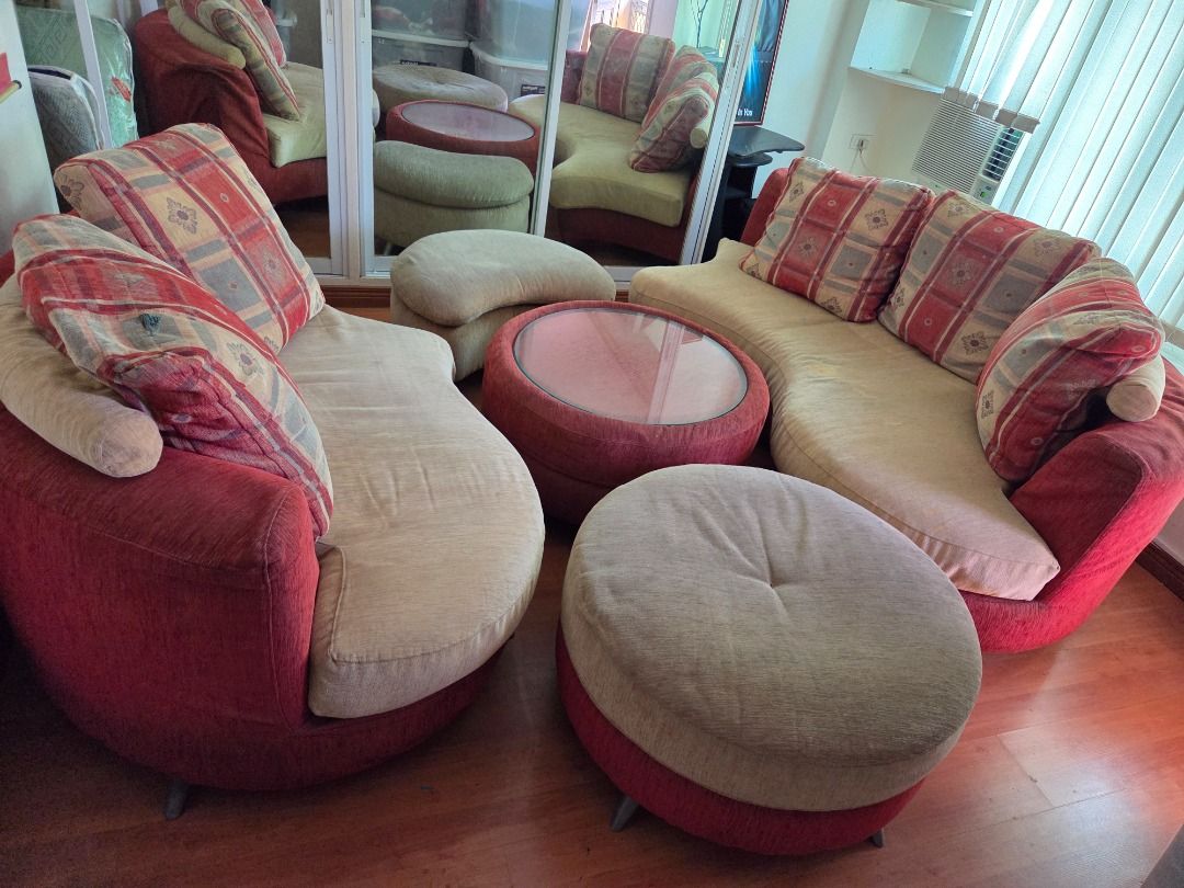 Curved Sectional Sofa Set with Coffee Table and Ottomans (Category: Sofas) located in Taguig. Submitted by maritoni_g (Listing ID 1469310034, Image 1). Description: - Imported from Malaysia - Complete living room set: red and beige curved sectional sofa - Includes matching round glass-top coffee table and 2 ottomans - Comes with stylish patterned throw pillows - Deep seating and warm fabric upholstery for maximum comfort - Selling as a full set o