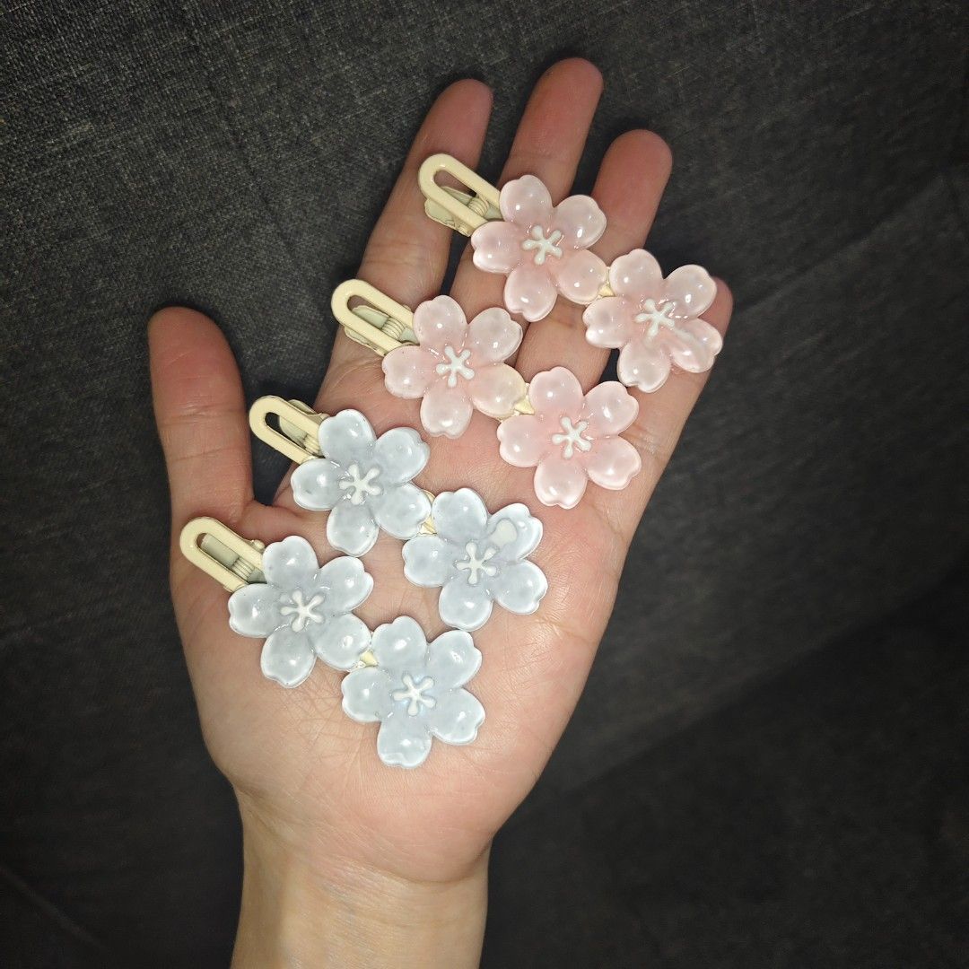 Cute Cherry Blossom Hair Clips Set (Category: Hair Accessories) located in Caloocan City. Submitted by abbyyaotuazon (Listing ID 1469209735, Image 1). Description: - Set of 4 adorable flower hair clips - Shades of pink and light blue with white centers - Shaped like sweet cherry blossoms.