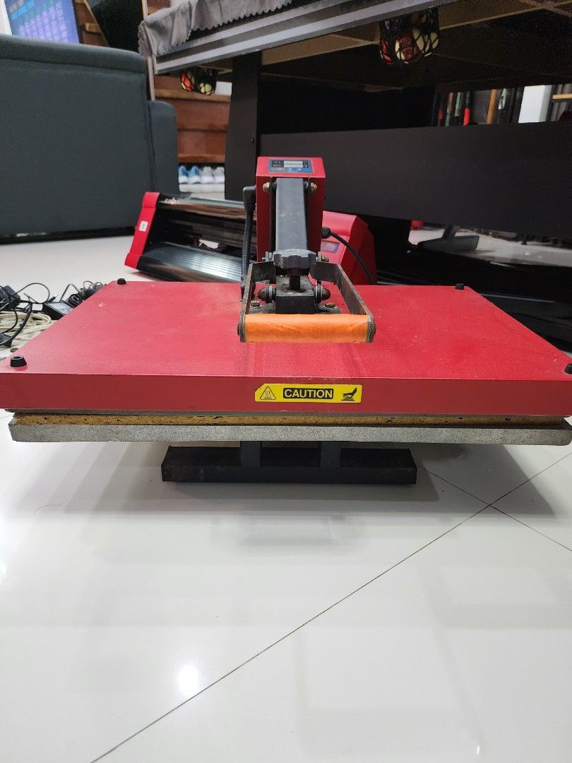 Cuyi Flat Heat Press Machine (Category: Tshirts & Polo Shirts ) located in Quezon City. Submitted by pinkyshang (Listing ID 1469206968, Image 3). Description: - Brand/Model: Cuyi Flat Heat Press Machine in Red and Black - Controls: Digital control panel for temperature and time settings - Build: Heavy-duty metal construction with Orange handle grip and bottom pressing pad - Condition: Powers on via standard cables; has minor rust spots from previ