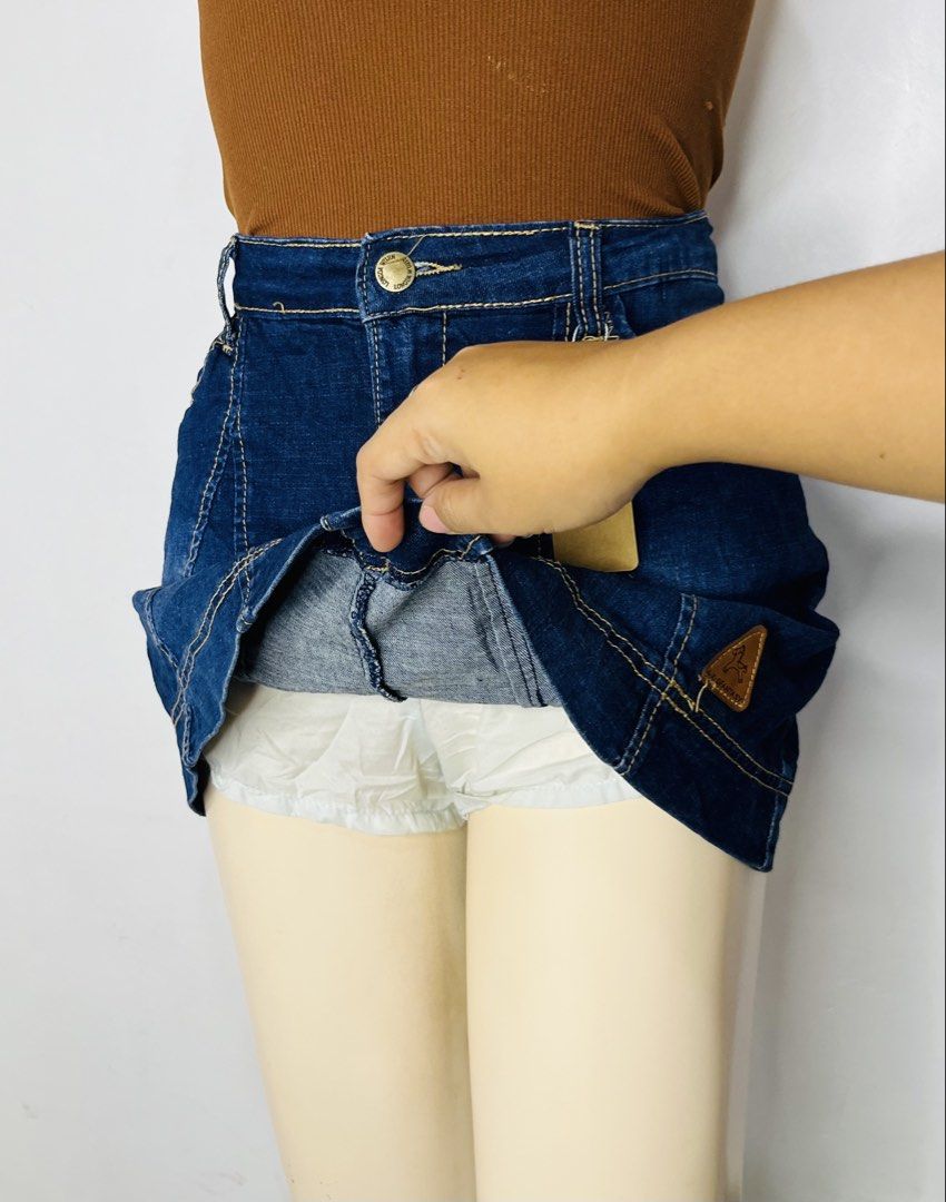 Dark Blue Denim Skort | S 29-30 (Category: Skirts) located in Manila. Submitted by bengirlclothing (Listing ID 1469298890, Image 3). Description: - Color: Dark blue denim with yellow contrast stitching - Style: High waist with front button closure - Comfort: Built-in white shorts underneath for safety - Detail: Small brown leather patch near the bottom hem - Size: Fits waist 29 to 30 inches - Length: 14 inches.