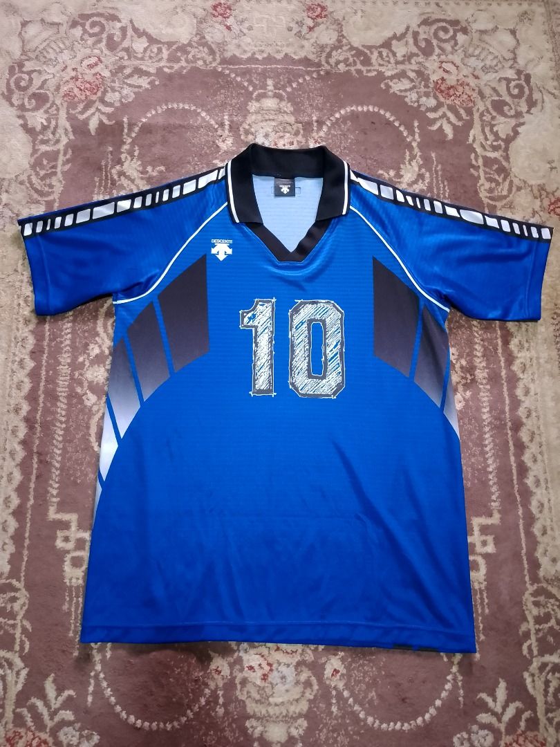 Descente Number 10 Blue Jersey (Category: Activewear) located in Bayombong. Submitted by daily10 (Listing ID 1469168972, Image 1). Description: - Authentic Descente sports jersey (Model DSS-4211, Made in Japan) - Color: Blue with gray side panels and geometric sleeve pattern - Number '10' printed in a stylish sketched design on front and back - Elegant black polo collar accented with white piping - Size: O JASPO (Fits chest 100cm, height 180cm) L