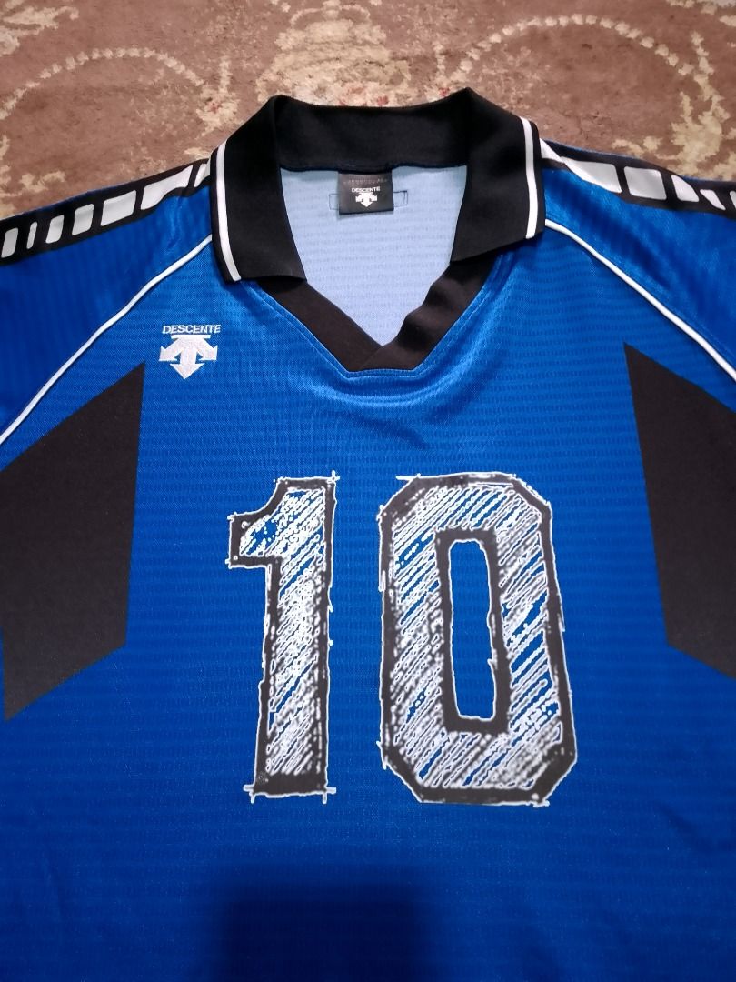 Descente Number 10 Blue Jersey (Category: Activewear) located in Bayombong. Submitted by daily10 (Listing ID 1469168972, Image 3). Description: - Authentic Descente sports jersey (Model DSS-4211, Made in Japan) - Color: Blue with gray side panels and geometric sleeve pattern - Number '10' printed in a stylish sketched design on front and back - Elegant black polo collar accented with white piping - Size: O JASPO (Fits chest 100cm, height 180cm) L