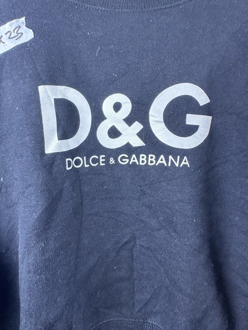 D&G Dolce & Gabbana Black Sweatshirt (Category: Coats, Jackets and Outerwear) located in Manila. Submitted by declutterpromax (Listing ID 1469223231, Image 2). Description: - Brand: D&G Dolce & Gabbana - Color: Classic black - Size/Measurements: Tag shows 18x20x23 inches (fits like a Large) - Design: Bold white logo on the chest, smaller logo detail on upper back - Details: Ribbed crewneck, cuffs, and hem, long sleeves - Material: Soft cotton fab