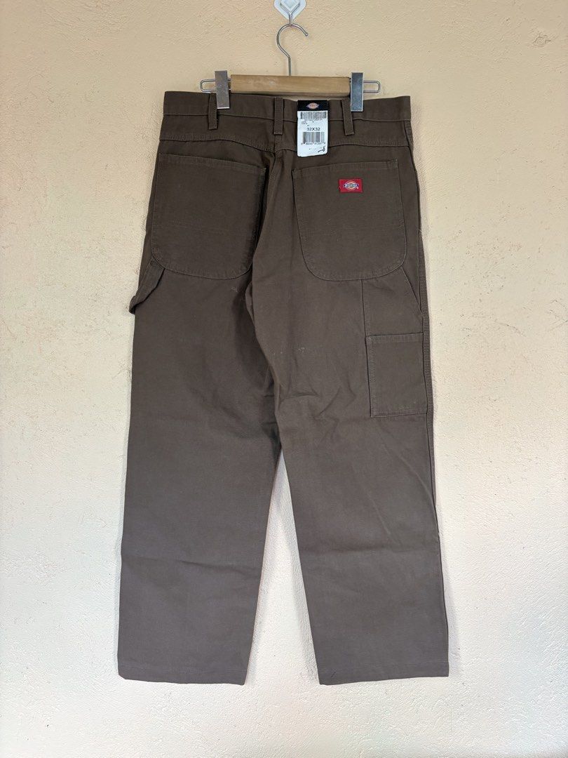 Dickies Brown Duck Canvas Carpenter Pants 32x32 (Category: Chinos) located in Pozorrubio. Submitted by zionegotthrift (Listing ID 1469199868, Image 2). Description: - Brand: Dickies - Style: Duck canvas carpenter pants - Color: Brown - Size: 32x32 - Condition: Brand new with original store tags attached - Features: Heavy-duty cotton material, classic workwear design, functional tool pockets, and hammer loop .