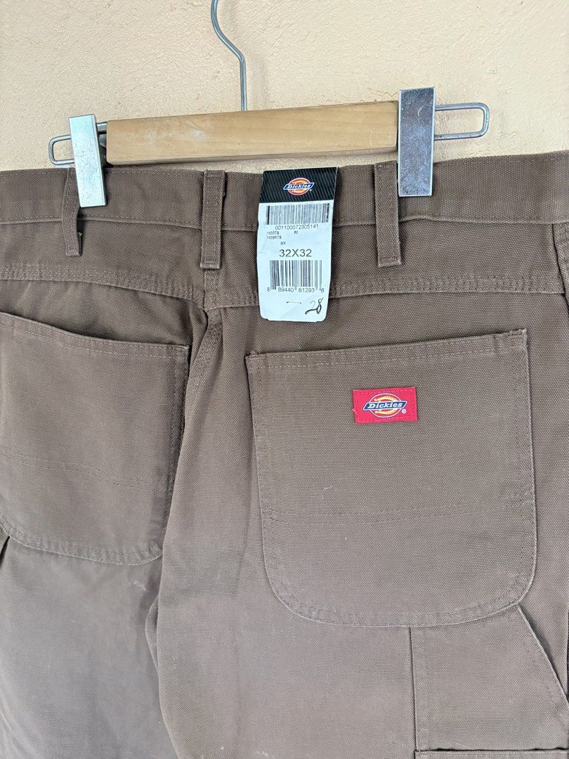 Dickies Brown Duck Canvas Carpenter Pants 32x32 (Category: Chinos) located in Pozorrubio. Submitted by zionegotthrift (Listing ID 1469199868, Image 3). Description: - Brand: Dickies - Style: Duck canvas carpenter pants - Color: Brown - Size: 32x32 - Condition: Brand new with original store tags attached - Features: Heavy-duty cotton material, classic workwear design, functional tool pockets, and hammer loop .