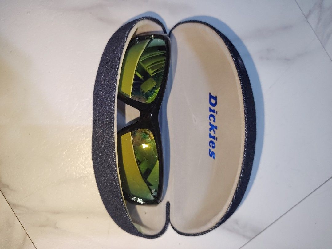 Dickies Sunglasses with Matching Hard Case (Category: Sunglasses & Eyewear) located in Quezon City. Submitted by zhelcloset01 (Listing ID 1469281010, Image 1). Description: - Brand: Dickies sunglasses - Lenses: Stylish greenish-yellow reflective tint - Frames: Sleek black full-coverage wrap design - Included: Matching blue denim-textured hard case with branded interior lining - Condition: Great everyday eyewear, perfect for daily use and travel p
