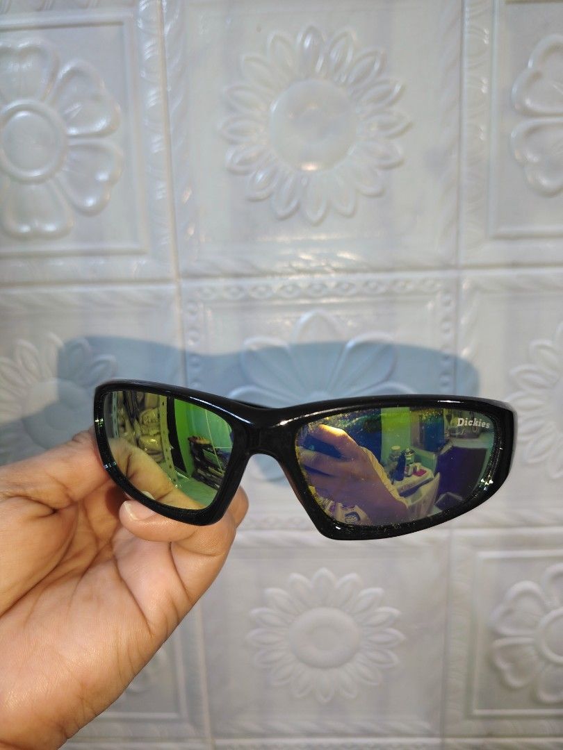 Dickies Sunglasses with Matching Hard Case (Category: Sunglasses & Eyewear) located in Quezon City. Submitted by zhelcloset01 (Listing ID 1469281010, Image 2). Description: - Brand: Dickies sunglasses - Lenses: Stylish greenish-yellow reflective tint - Frames: Sleek black full-coverage wrap design - Included: Matching blue denim-textured hard case with branded interior lining - Condition: Great everyday eyewear, perfect for daily use and travel p