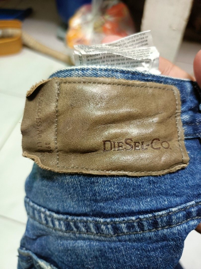 Diesel Co. Distressed Blue Denim Jeans (Category: Jeans) located in Manila. Submitted by pnjdianne25879 (Listing ID 1469211393, Image 3). Description: 32 x 38 exact dimension very excellent condition - Brand: Diesel Co. - Color/Wash: Blue with faded wash and factory distressing - Closure: Button fly - Features: Classic five-pocket styling, intentional wear on back pocket and knee, branded leather back patch, and small coin pocket logo tag - Condi
