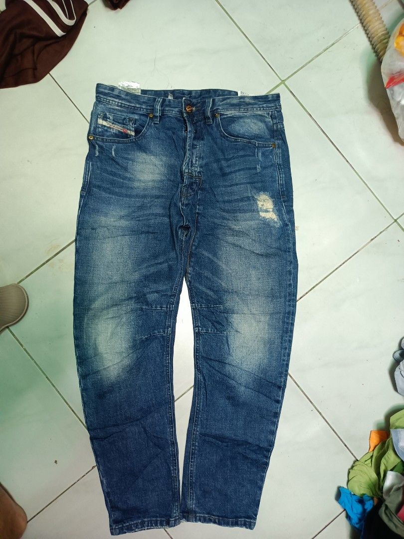 Diesel Co. Distressed Blue Denim Jeans (Category: Jeans) located in Manila. Submitted by pnjdianne25879 (Listing ID 1469211393, Image 1). Description: 32 x 38 exact dimension very excellent condition - Brand: Diesel Co. - Color/Wash: Blue with faded wash and factory distressing - Closure: Button fly - Features: Classic five-pocket styling, intentional wear on back pocket and knee, branded leather back patch, and small coin pocket logo tag - Condi