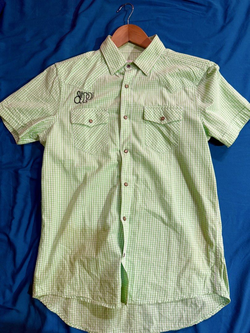 Diesel Lime Green Gingham Short Sleeve Button Down Shirt Size S (Category: Tshirts & Polo Shirts ) located in Manila. Submitted by rojotesoro (Listing ID 1469225513, Image 1). Description: - Brand: Diesel - Design: Green and white gingham check pattern - Size: S width: 19 length: 26 (front) 29 (back) - Closure & Pockets: Snap buttons down the front and on both chest pockets - Details: Embroidered “dp passion logo” patch above the right pocket - C