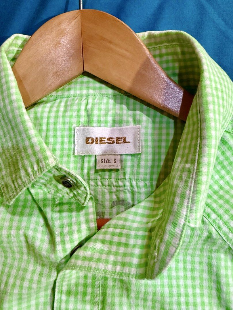 Diesel Lime Green Gingham Short Sleeve Button Down Shirt Size S (Category: Tshirts & Polo Shirts ) located in Manila. Submitted by rojotesoro (Listing ID 1469225513, Image 3). Description: - Brand: Diesel - Design: Green and white gingham check pattern - Size: S width: 19 length: 26 (front) 29 (back) - Closure & Pockets: Snap buttons down the front and on both chest pockets - Details: Embroidered “dp passion logo” patch above the right pocket - C