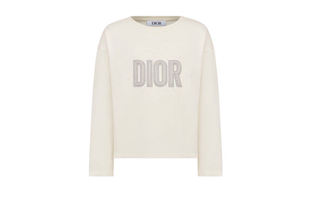 Dior Long Sleeve Crystal Logo Tee (Category: Longsleeves) located in Tabuk. Submitted by collectors_thrift_shop (Listing ID 1469168412, Image 1). Description: - Brand: Dior - Color: White - Size: 13 - Material: Comfortable cotton - Design: Textured Dior lettering on the chest with crystal embellishments and a classic round neckline - Condition: Clean with no major stains or flaws - Style: Great everyday layering piece.