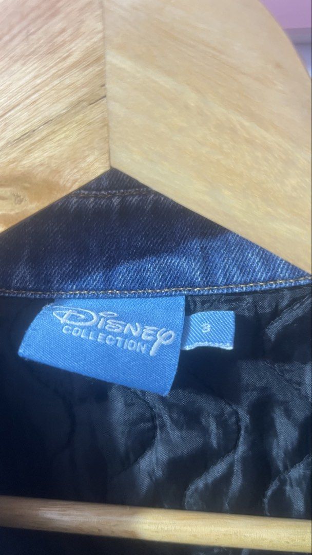 Disney Collection Denim Jacket Mickey Mouse Size S (Category: Coats, Jackets and Outerwear) located in Pasig City. Submitted by morilove (Listing ID 1469187876, Image 3). Description: - Authentic Disney Collection denim jacket in a classic blue wash - Detailed Mickey and Pluto embroidery on the back yoke - Mickey Mouse lettering embroidery near the front hem - Button-up front with custom Mickey icon embossed hardware - Functional chest flap pocke